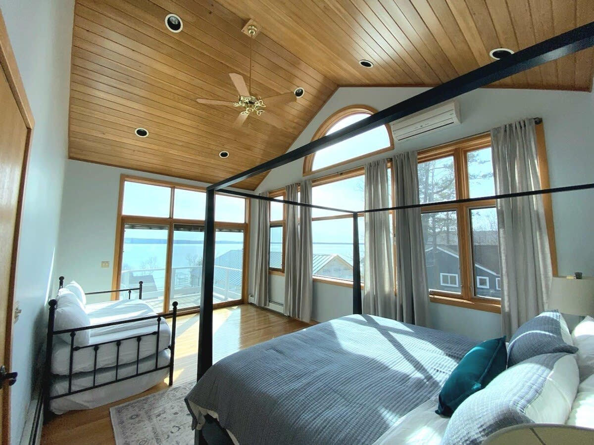 Sunlit lakefront bedroom professionally cleaned by Passively LLC